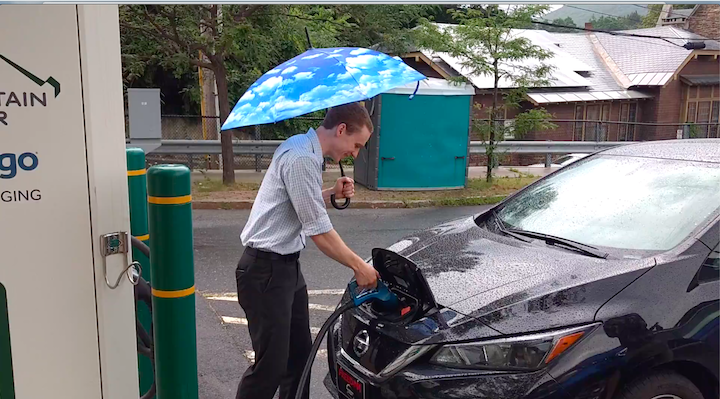 man disconnecting EV charger